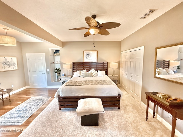 2948 N Ocean Shore Blvd, Flagler Beach, FL 32136 - bedroom featuring ceiling fan, baseboards, wood finished floors, visible vents, and a closet