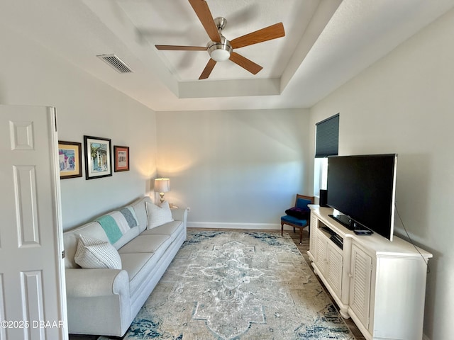 2948 N Ocean Shore Blvd, Flagler Beach, FL 32136 - living room with baseboards, a ceiling fan, a tray ceiling, and visible vents
