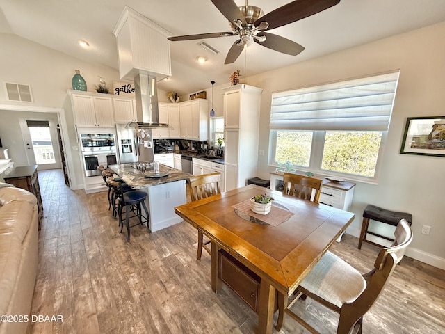 2948 N Ocean Shore Blvd, Flagler Beach, FL 32136 - dining space featuring visible vents, a ceiling fan, plenty of natural light, and vaulted ceiling