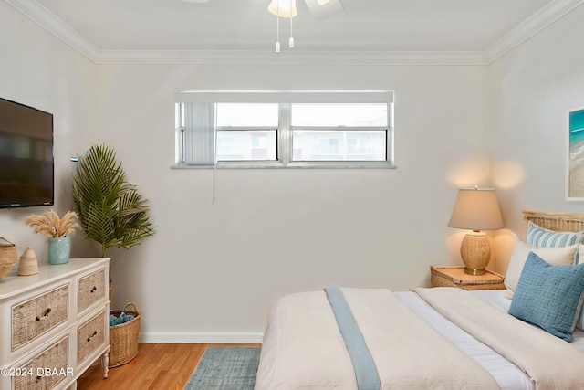 bedroom featuring ceiling fan, light hardwood / wood-style flooring, and crown molding