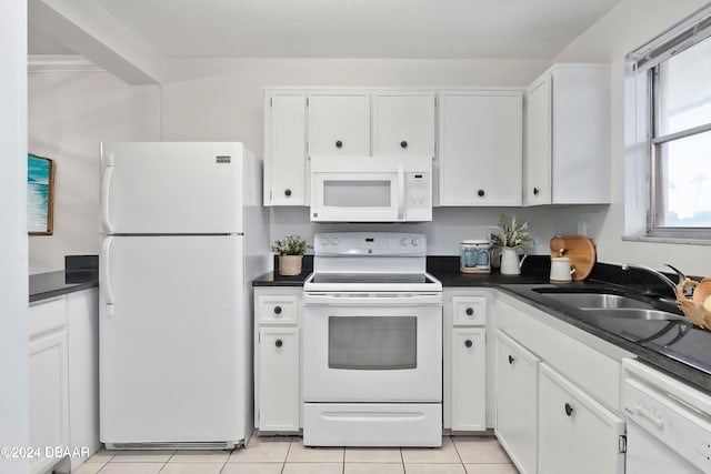 kitchen featuring white cabinetry, sink, light tile patterned floors, and white appliances