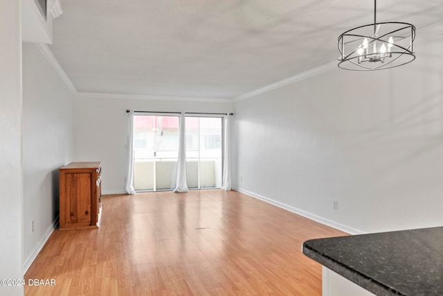 unfurnished living room with a chandelier, light hardwood / wood-style floors, and ornamental molding