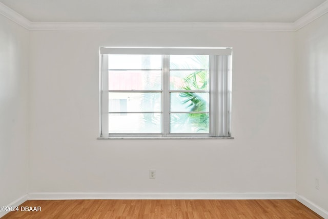 empty room featuring light hardwood / wood-style floors and ornamental molding