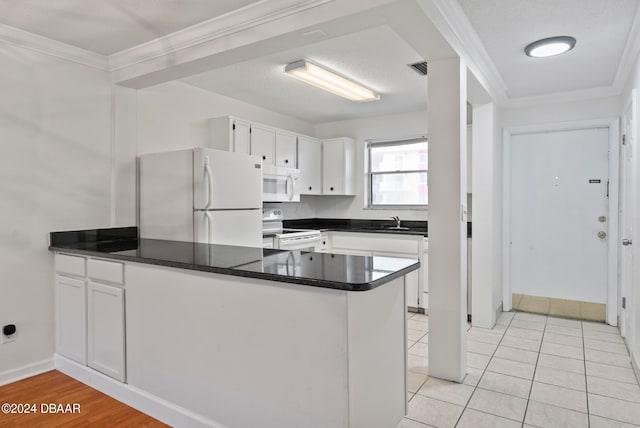 kitchen featuring white cabinets, kitchen peninsula, white appliances, and crown molding