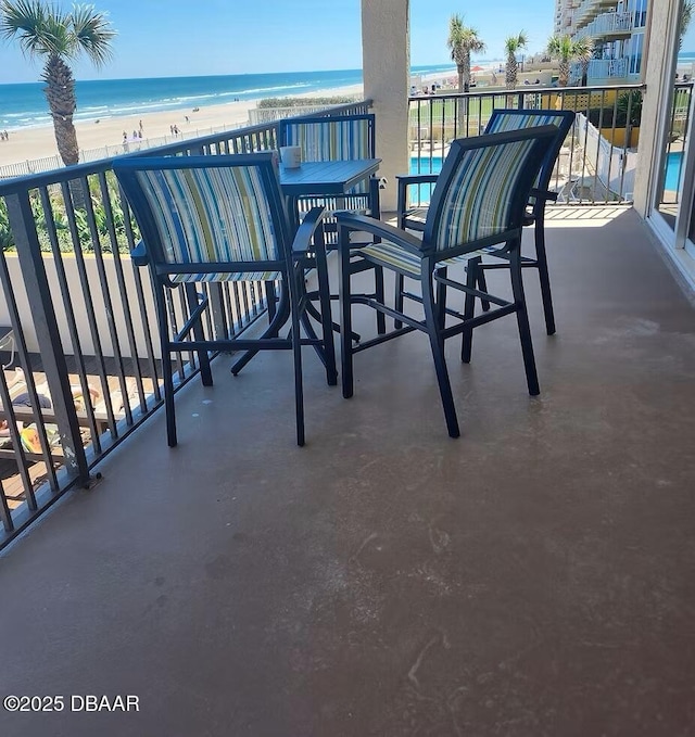 3807 S Atlantic Ave Unit 203, Daytona Beach, FL 32118 - view of patio featuring view of water and beach and a balcony