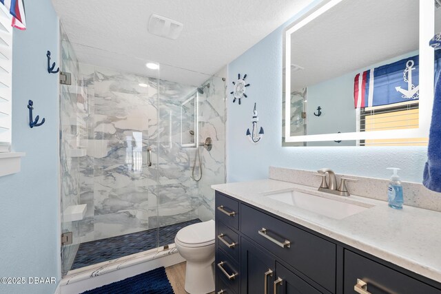 3807 S Atlantic Ave Unit 203, Daytona Beach, FL 32118 - full bath with toilet, vanity, a marble finish shower, and a textured ceiling