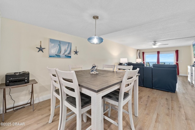3807 S Atlantic Ave Unit 203, Daytona Beach, FL 32118 - dining room with ceiling fan, light wood-style flooring, a textured ceiling, and baseboards