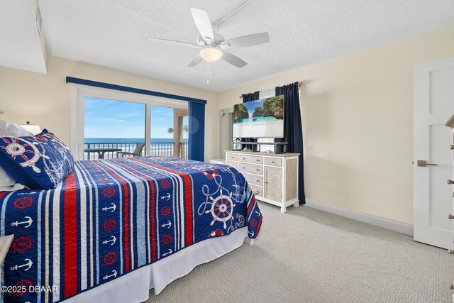 3807 S Atlantic Ave Unit 203, Daytona Beach, FL 32118 - carpeted bedroom with access to outside, a textured ceiling, baseboards, and a ceiling fan