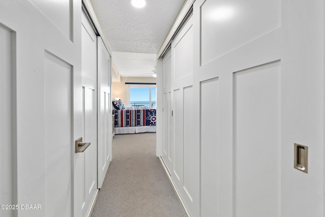 3807 S Atlantic Ave Unit 203, Daytona Beach, FL 32118 - corridor featuring carpet flooring and a textured ceiling