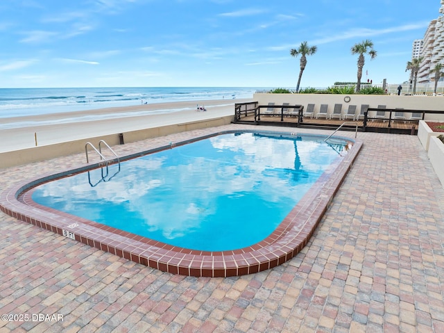 3807 S Atlantic Ave Unit 203, Daytona Beach, FL 32118 - community pool featuring a water view and a patio