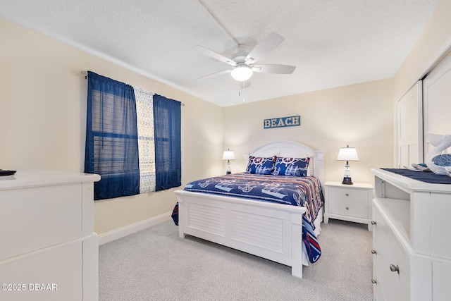 3807 S Atlantic Ave Unit 203, Daytona Beach, FL 32118 - bedroom with light colored carpet, a textured ceiling, a ceiling fan, and baseboards