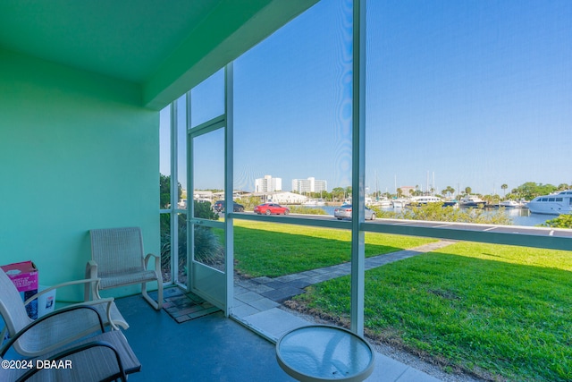 sunroom / solarium featuring a water view