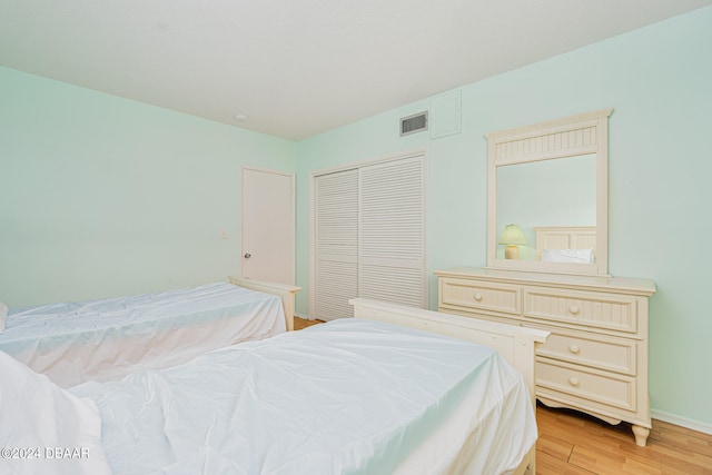 bedroom with a closet and light hardwood / wood-style flooring