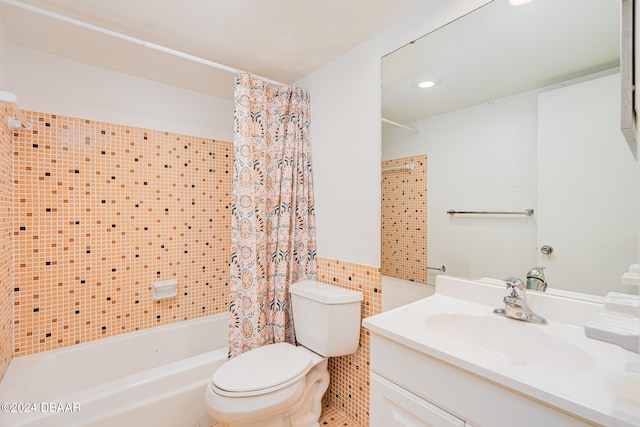 full bathroom featuring vanity, toilet, tile walls, and shower / tub combo