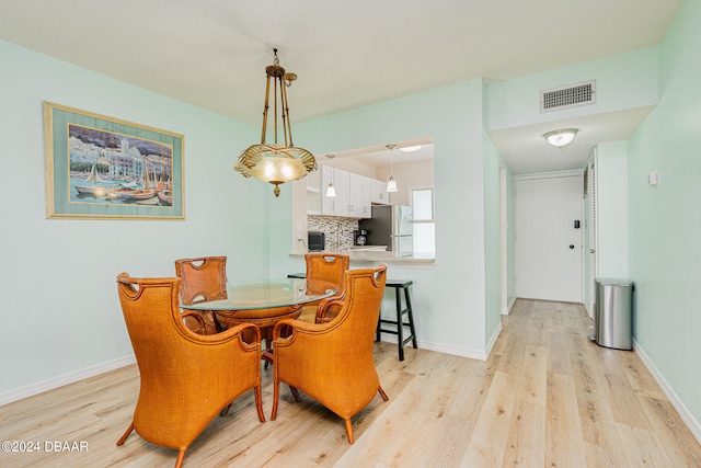 dining area featuring light wood-type flooring