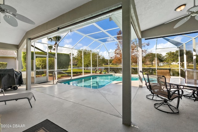 view of swimming pool with ceiling fan, a lanai, a patio, and grilling area