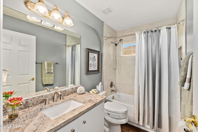 full bathroom with shower / bath combo with shower curtain, vanity, hardwood / wood-style floors, and toilet