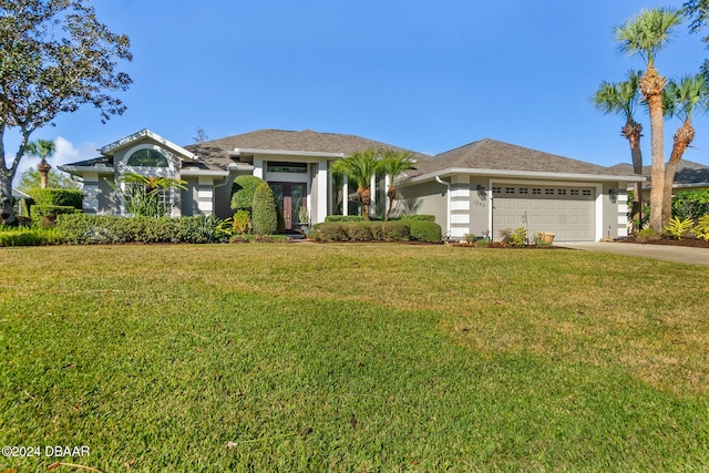 view of front of house featuring a garage and a front lawn