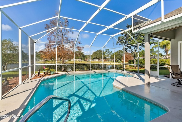 view of pool with a lanai, a patio area, and a water view