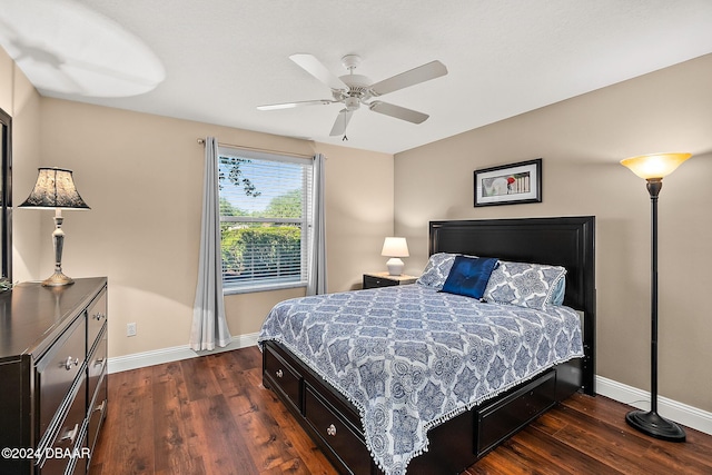 bedroom with ceiling fan and dark hardwood / wood-style flooring