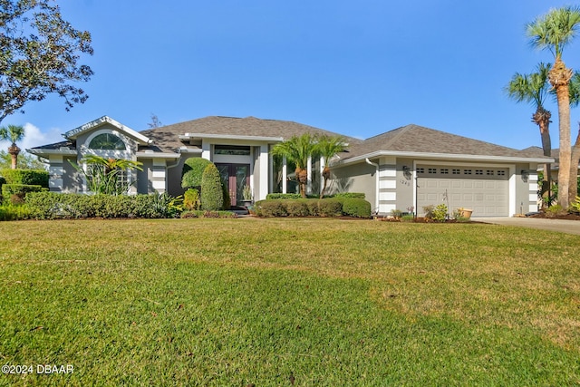 view of front of home featuring a garage and a front yard