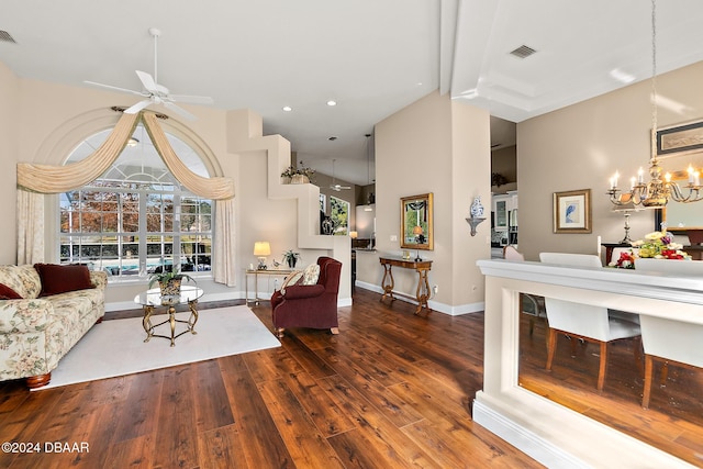 living room with ceiling fan with notable chandelier, beam ceiling, dark hardwood / wood-style flooring, and high vaulted ceiling