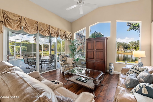 living room with ceiling fan, a water view, dark wood-type flooring, and lofted ceiling