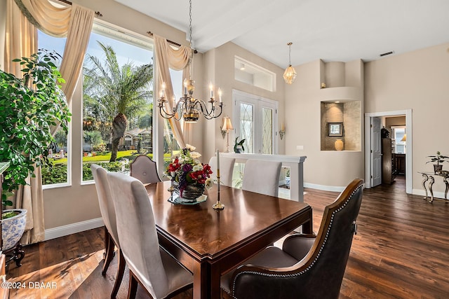 dining area with dark hardwood / wood-style flooring, plenty of natural light, a chandelier, and french doors