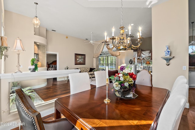 dining room featuring lofted ceiling, ceiling fan with notable chandelier, and hardwood / wood-style flooring