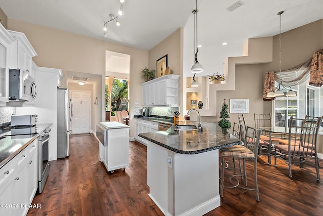 kitchen featuring backsplash, plenty of natural light, pendant lighting, and appliances with stainless steel finishes