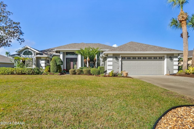 ranch-style home with a garage and a front lawn