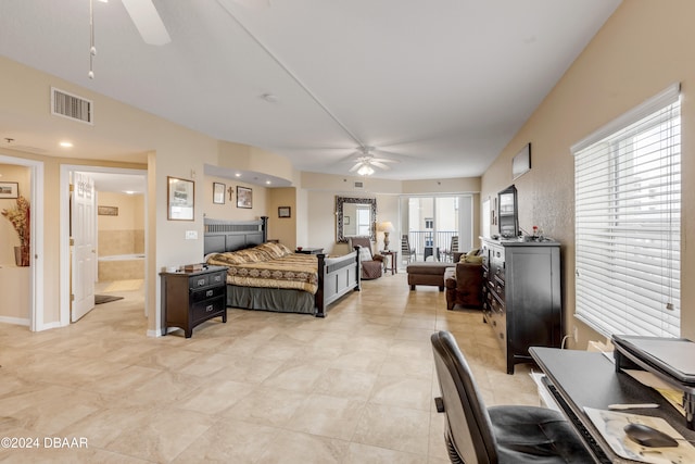 bedroom with ceiling fan, connected bathroom, and light tile patterned floors