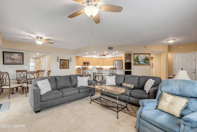 tiled living room with ceiling fan