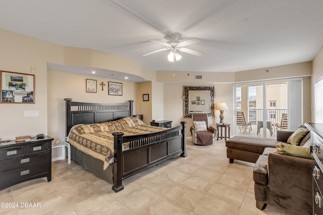 bedroom featuring access to outside, a textured ceiling, and ceiling fan