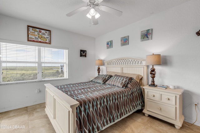 bedroom with ceiling fan and light tile patterned floors