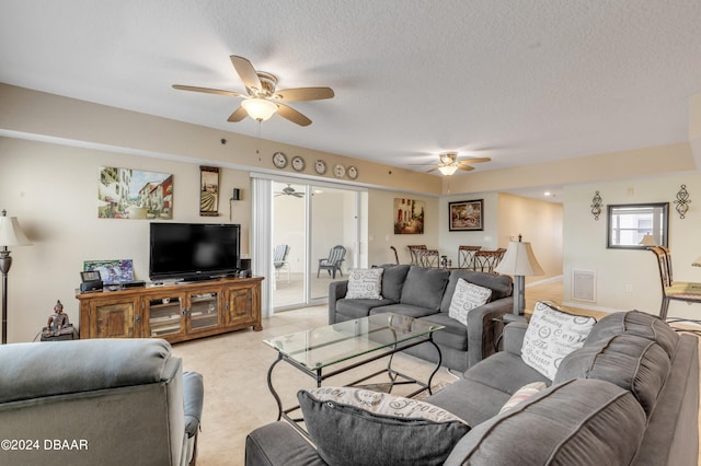 living room with a textured ceiling and ceiling fan