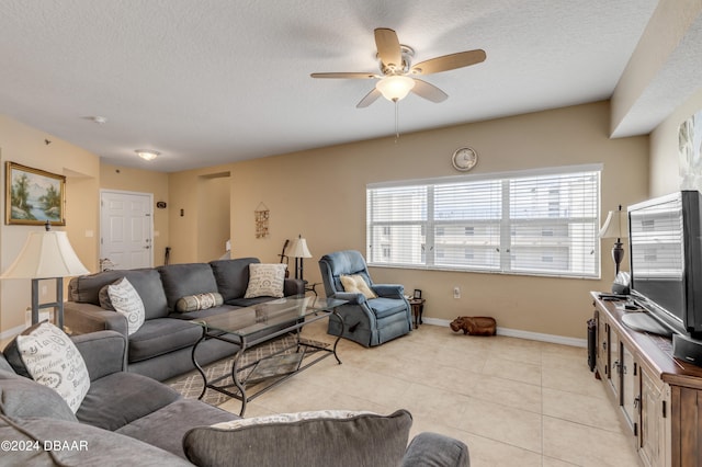 tiled living room with ceiling fan and a textured ceiling