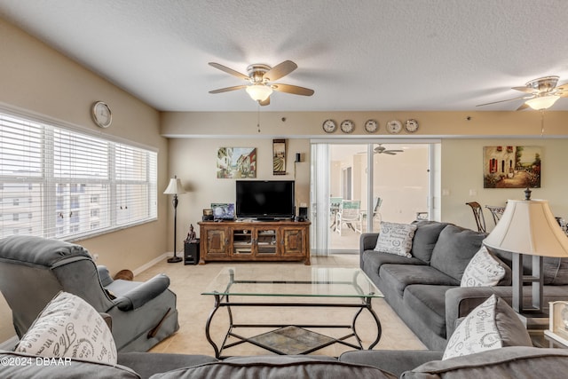 living room with a textured ceiling and ceiling fan