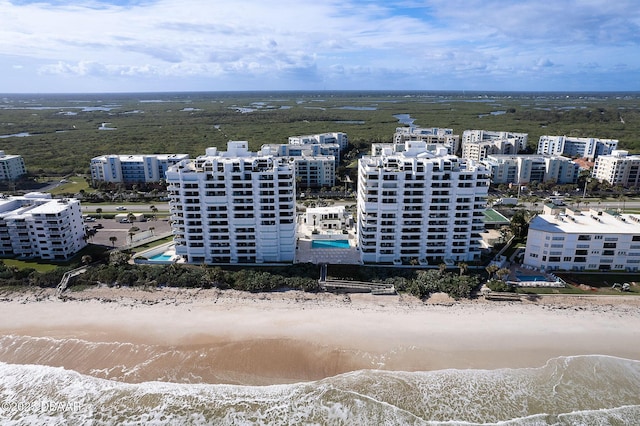 aerial view with a water view and a view of the beach