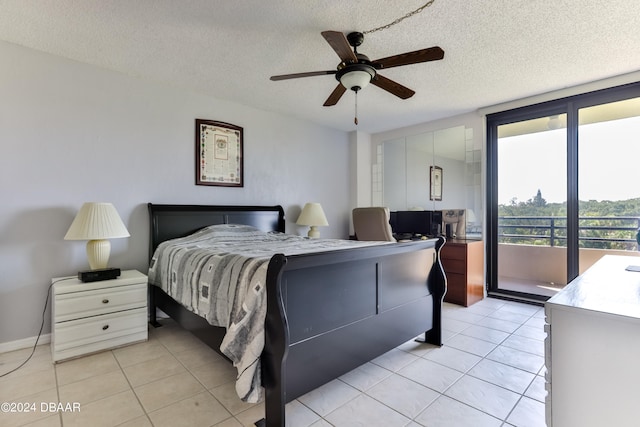 tiled bedroom featuring access to exterior, a textured ceiling, and ceiling fan