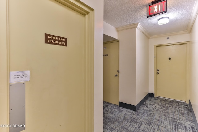 corridor with a textured ceiling and crown molding