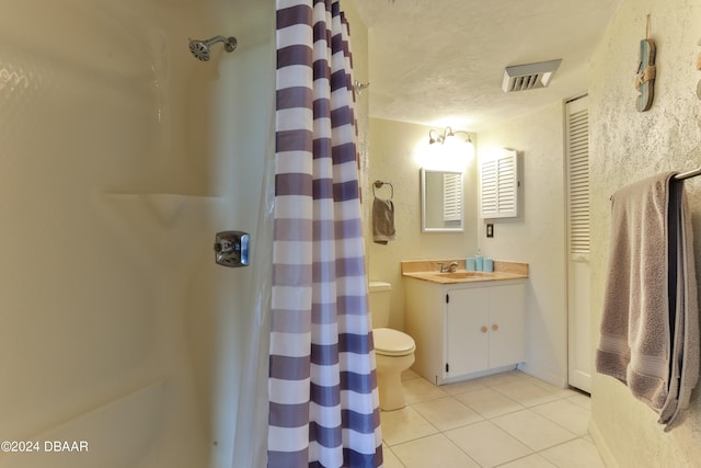 bathroom featuring tile patterned flooring, a textured ceiling, curtained shower, vanity, and toilet