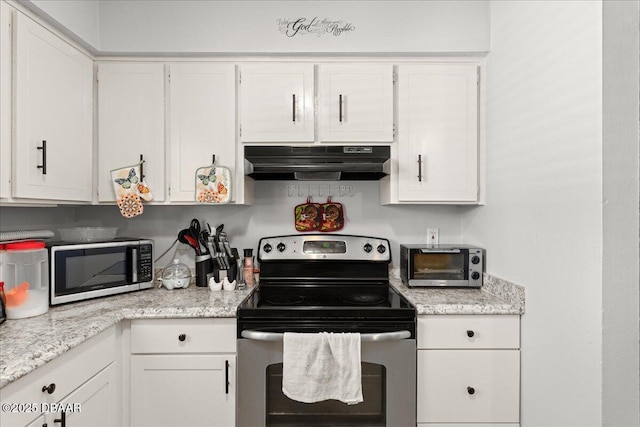 kitchen with under cabinet range hood, a toaster, white cabinetry, and stainless steel appliances