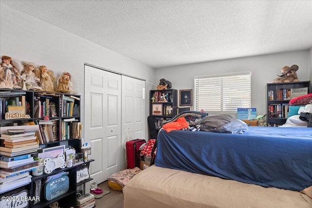 bedroom with a textured ceiling and a closet