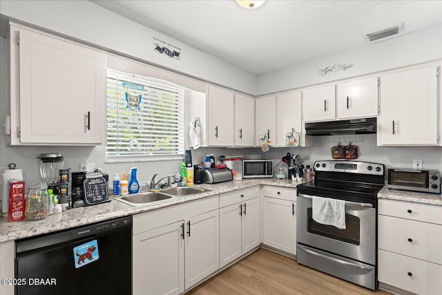 kitchen with a toaster, stainless steel appliances, light countertops, a sink, and under cabinet range hood