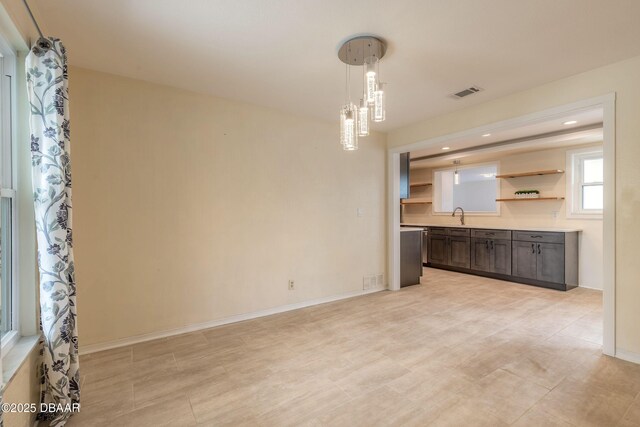 73 N St Andrews Dr, Ormond Beach, FL 32174 - unfurnished dining area featuring a sink, recessed lighting, and baseboards