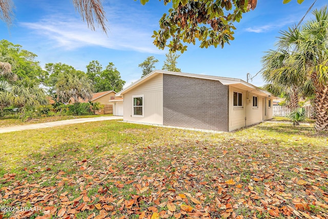 73 N St Andrews Dr, Ormond Beach, FL 32174 - view of side of property with brick siding and a garage