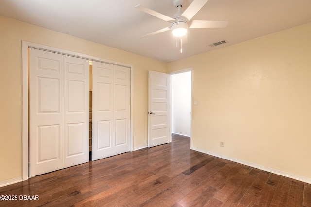 73 N St Andrews Dr, Ormond Beach, FL 32174 - unfurnished bedroom with dark wood finished floors, a closet, baseboards, and ceiling fan