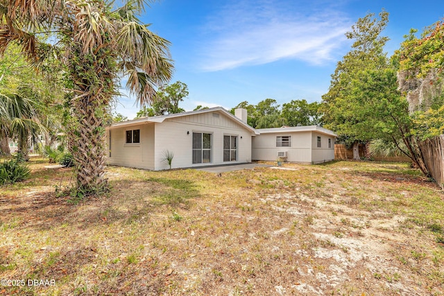 73 N St Andrews Dr, Ormond Beach, FL 32174 - rear view of house with fence and a chimney