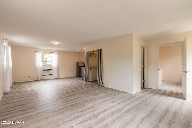 73 N St Andrews Dr, Ormond Beach, FL 32174 - unfurnished living room with light wood-style floors and baseboards
